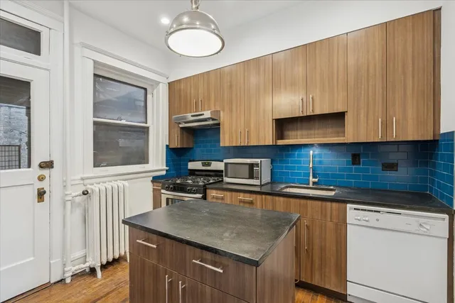 a kitchen with a refrigerator and cabinets