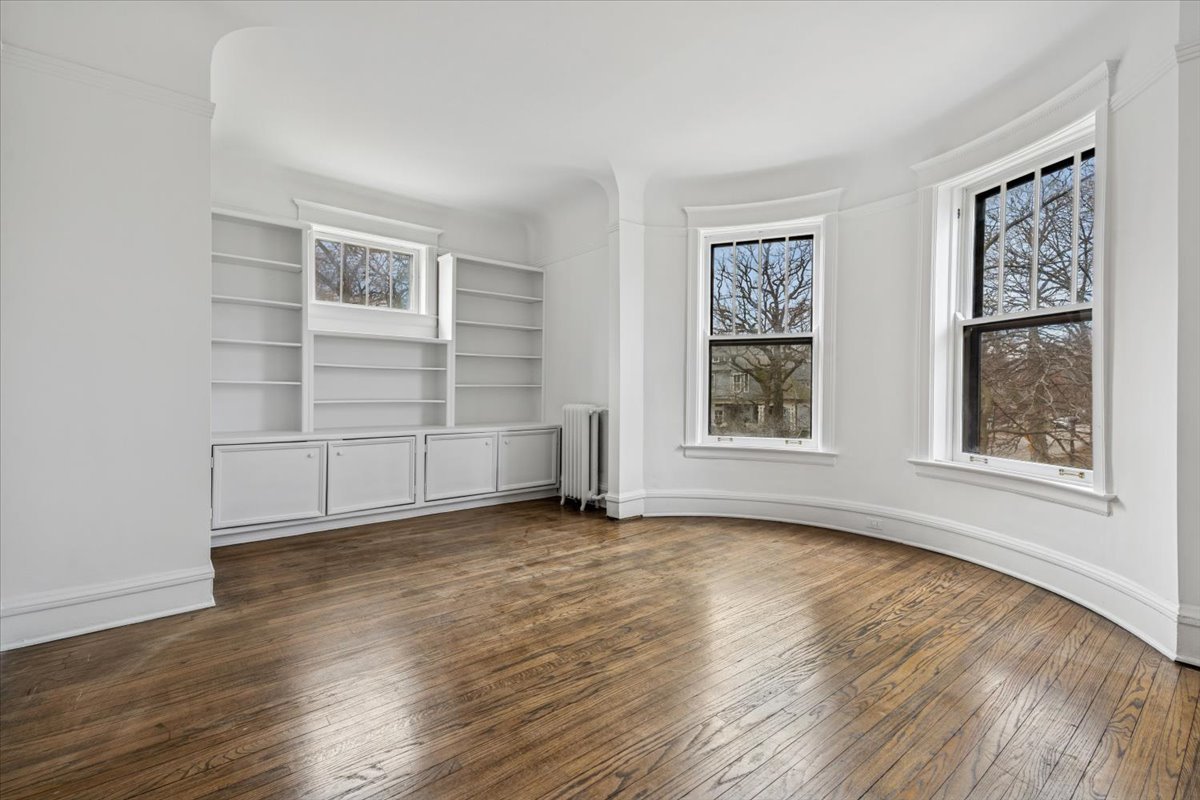 1201 Michigan Avenue, Unit 2 Evanston, IL 60202 - Photo 4 of 20 a view of an empty room with a window and wooden floor