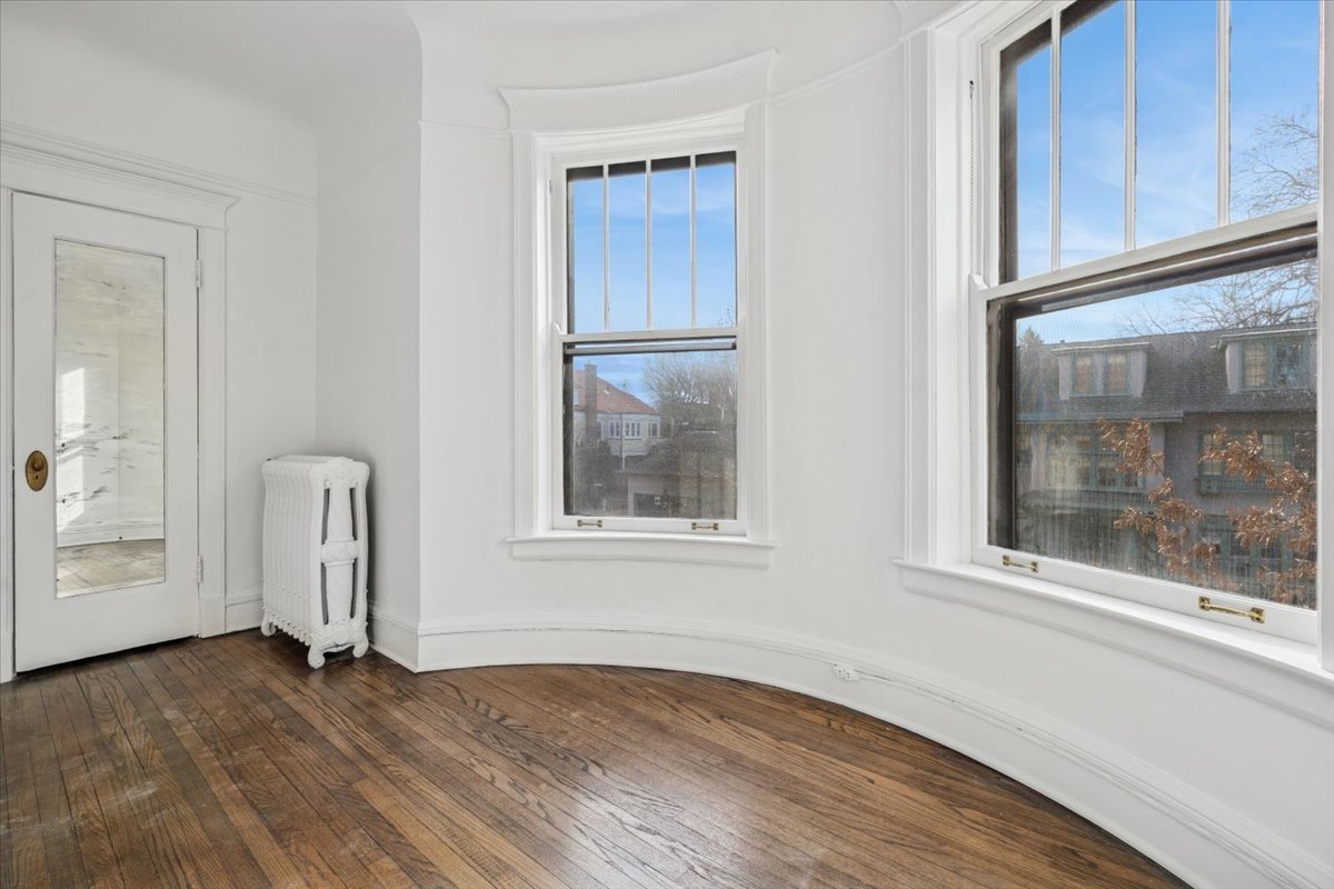 1201 Michigan Avenue, Unit 2 Evanston, IL 60202 - Photo 7 of 20 an empty room with wooden floor and windows