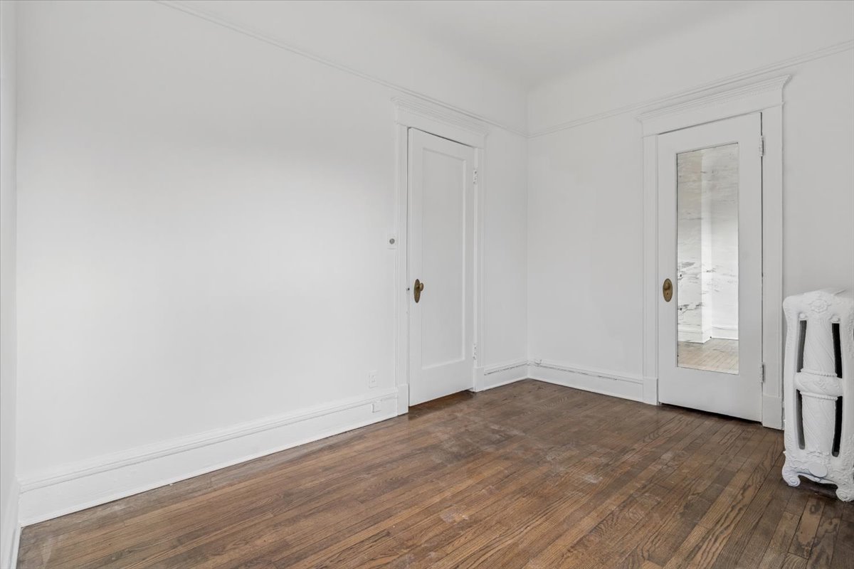 1201 Michigan Avenue, Unit 2 Evanston, IL 60202 - Photo 8 of 20 an empty room with wooden floor and a fireplace