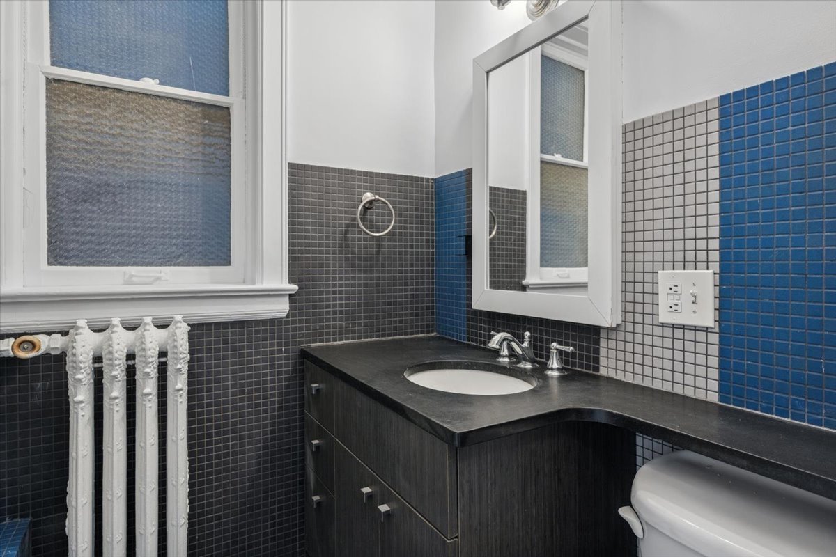 1201 Michigan Avenue, Unit 2 Evanston, IL 60202 - Photo 9 of 20 a bathroom with a sink and a mirror