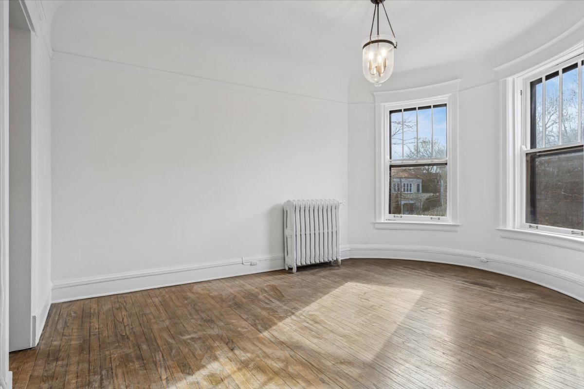1201 Michigan Avenue, Unit 2 Evanston, IL 60202 - Photo 10 of 20 an empty room with wooden floor cabinet and windows