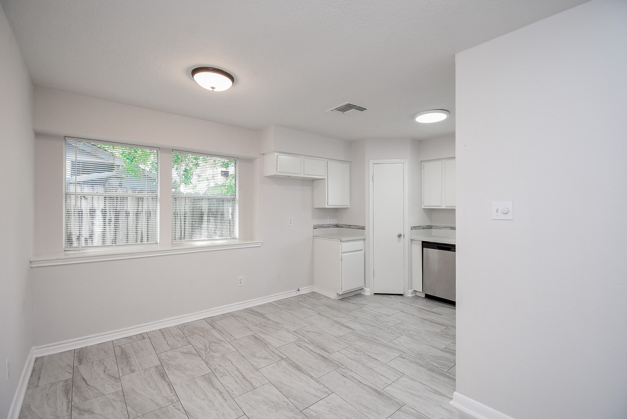9527 Kingsvalley Drive Houston, TX 77075 - Photo 13 of 45 a view of a kitchen with wooden floor and electronic appliances