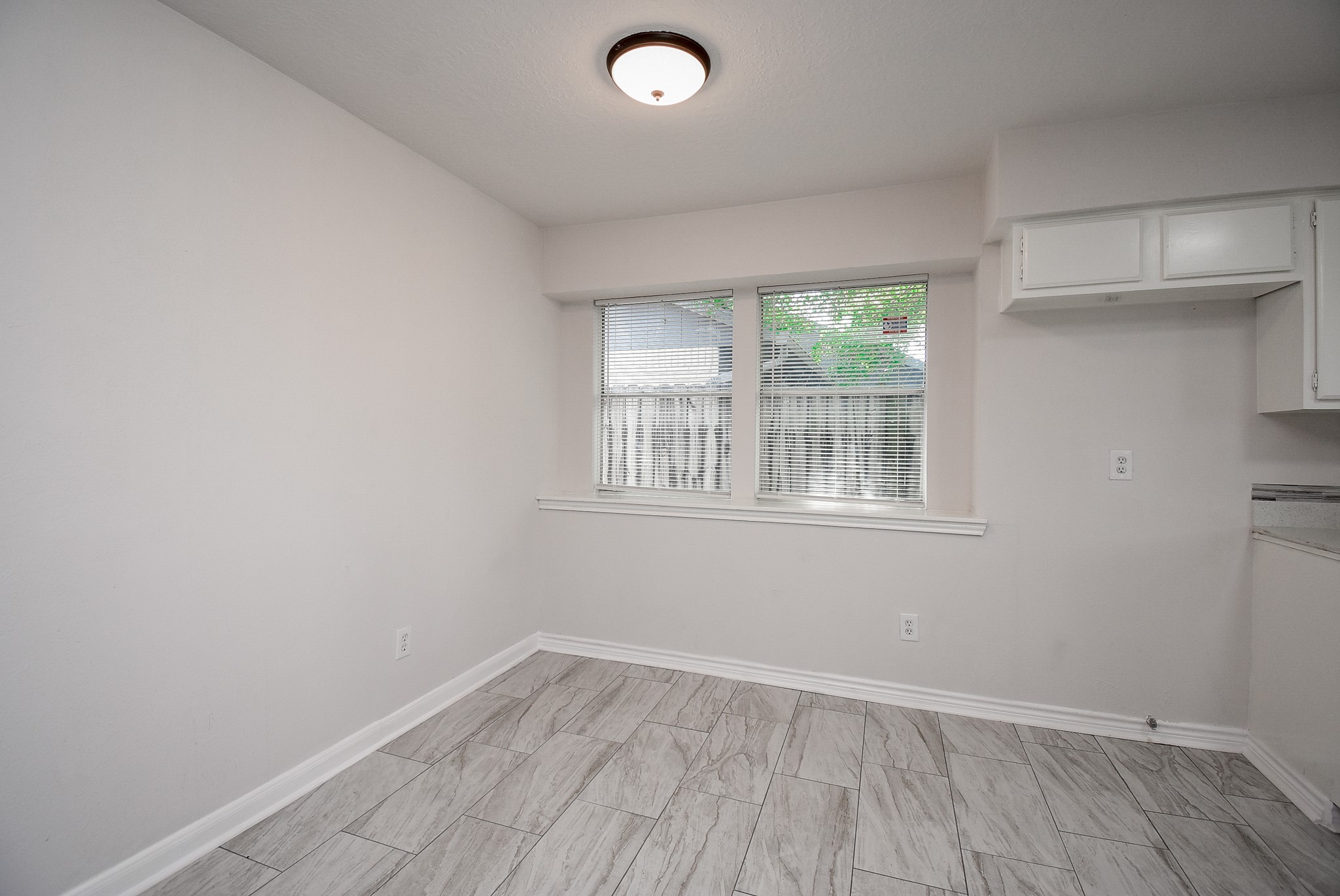 9527 Kingsvalley Drive Houston, TX 77075 - Photo 14 of 45 an empty room with wooden floor and windows