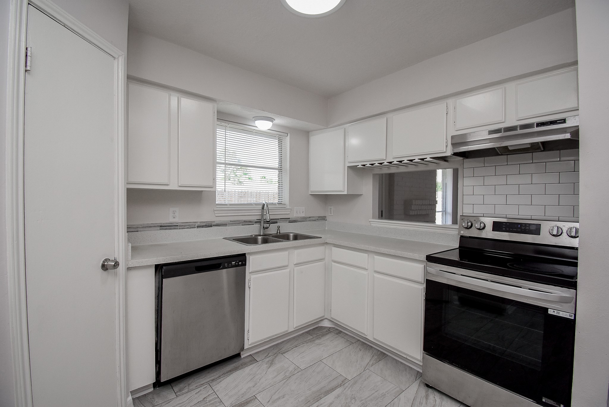 9527 Kingsvalley Drive Houston, TX 77075 - Photo 19 of 45 a kitchen with a sink stove and cabinets
