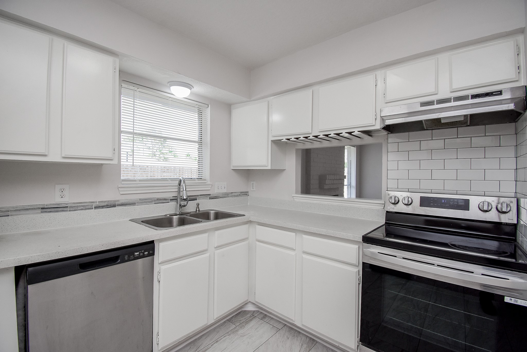 9527 Kingsvalley Drive Houston, TX 77075 - Photo 20 of 45 a kitchen with a sink stove and cabinets