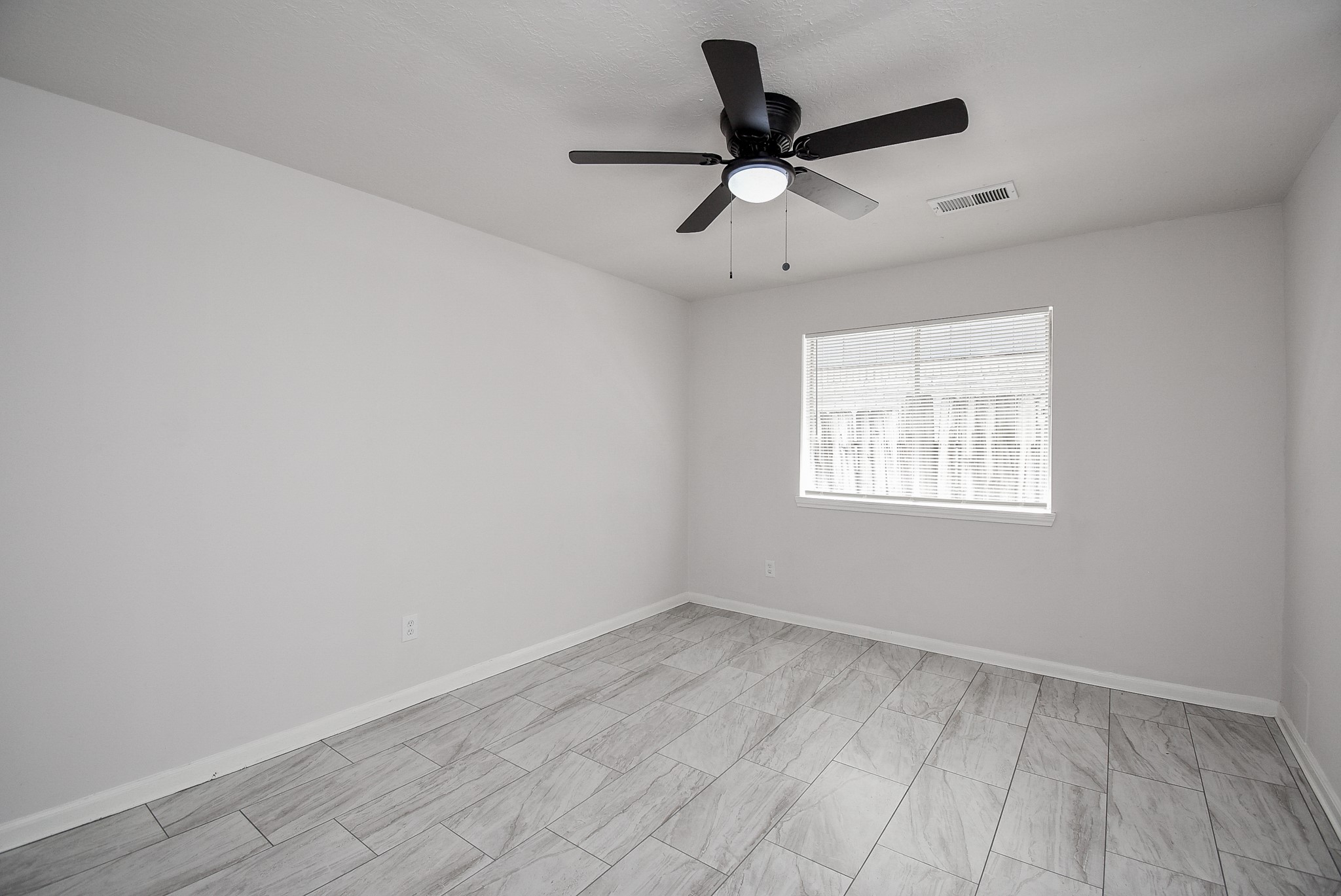 9527 Kingsvalley Drive Houston, TX 77075 - Photo 22 of 45 wooden floor in an empty room with a window