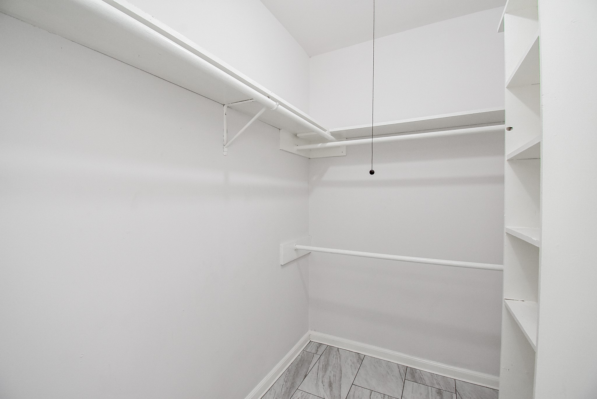 9527 Kingsvalley Drive Houston, TX 77075 - Photo 29 of 45 a view of walk in closet with empty racks