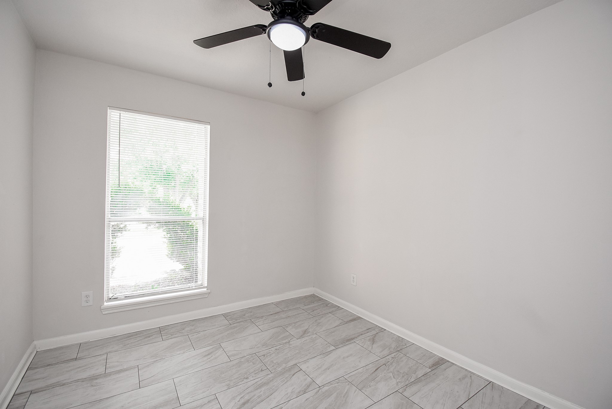 9527 Kingsvalley Drive Houston, TX 77075 - Photo 30 of 45 an empty room with a window and a fan