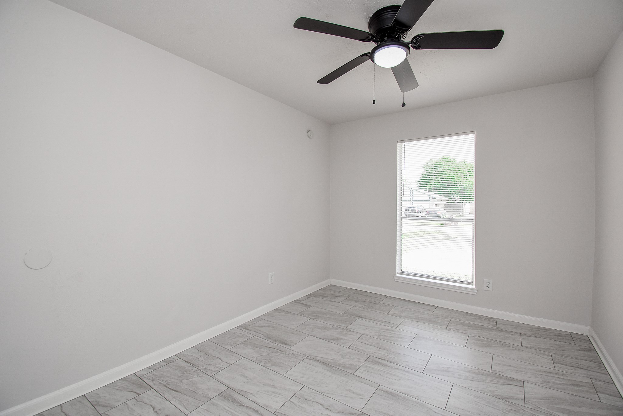 9527 Kingsvalley Drive Houston, TX 77075 - Photo 32 of 45 an empty room with a window and a fan