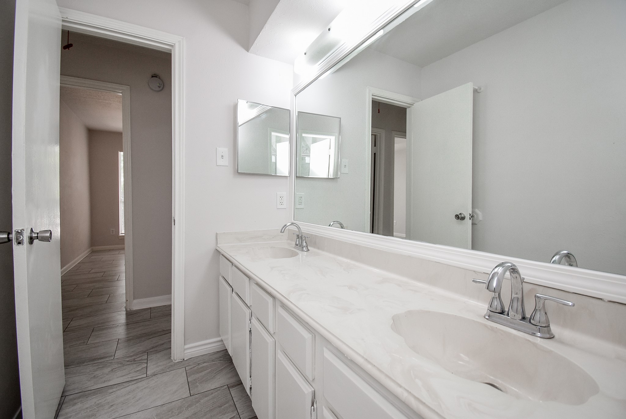 9527 Kingsvalley Drive Houston, TX 77075 - Photo 34 of 45 a bathroom with a double vanity sink and a mirror