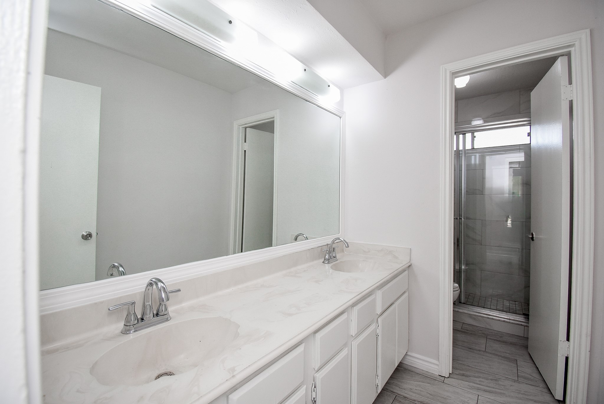 9527 Kingsvalley Drive Houston, TX 77075 - Photo 35 of 45 a bathroom with a double vanity sink and a mirror