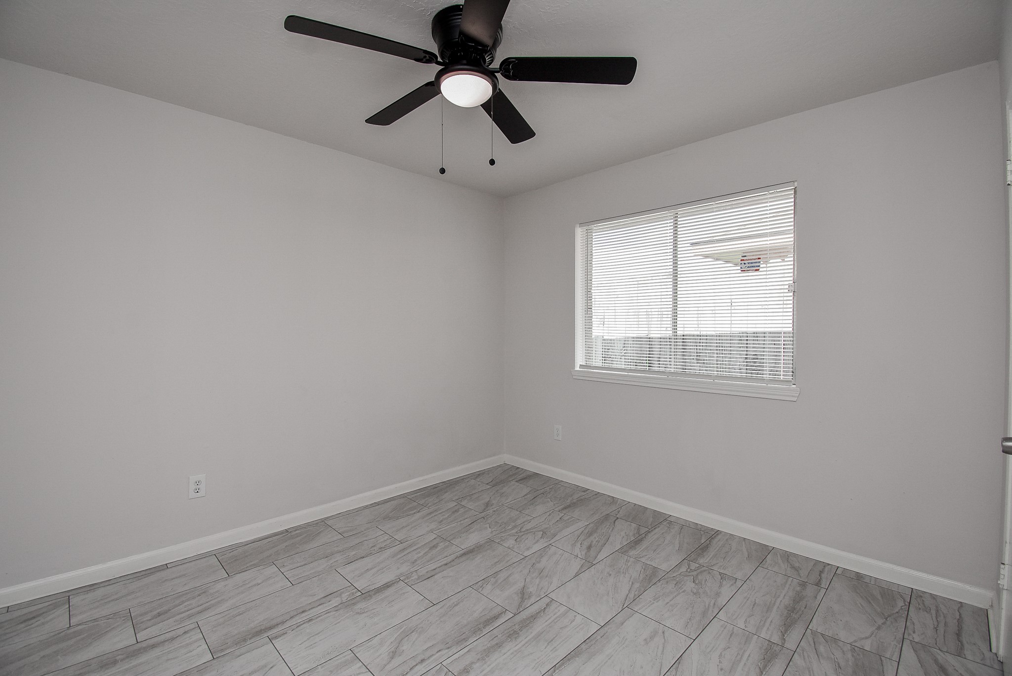 9527 Kingsvalley Drive Houston, TX 77075 - Photo 37 of 45 an empty room with a window and a fan