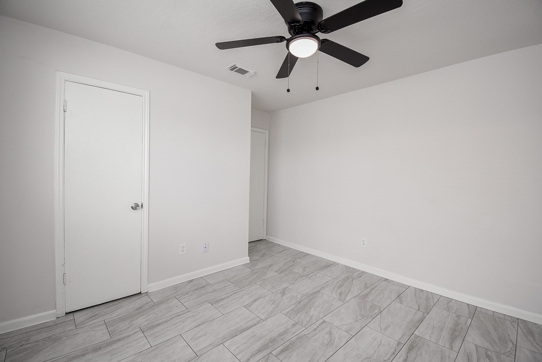 9527 Kingsvalley Drive Houston, TX 77075 - Photo 38 of 45 an empty room with a ceiling fan and wooden floor