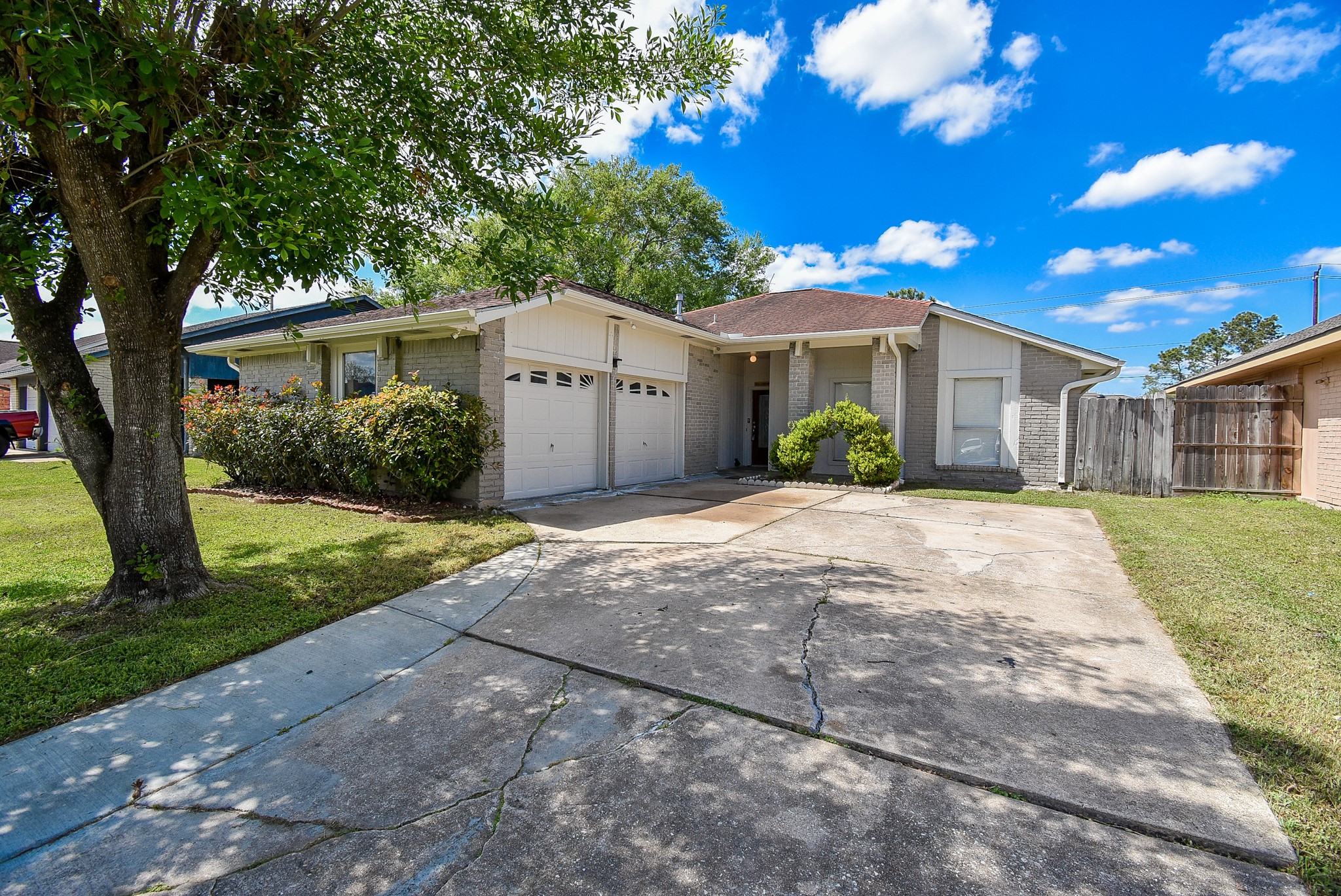 9527 Kingsvalley Drive Houston, TX 77075 - Photo 4 of 45 a front view of a house with a yard and garage
