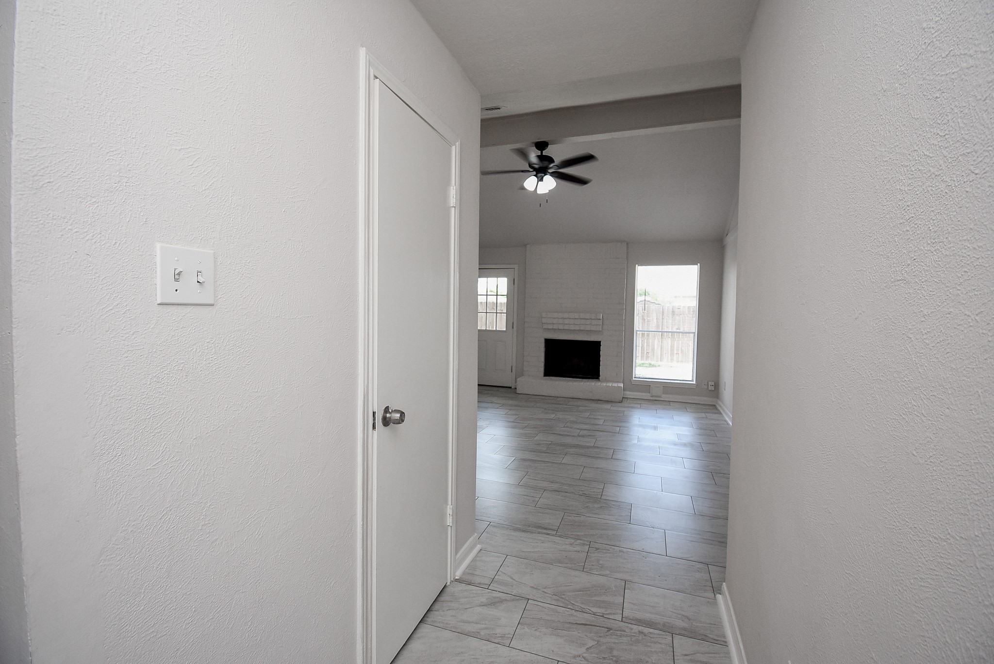 9527 Kingsvalley Drive Houston, TX 77075 - Photo 7 of 45 a view of empty room with a fireplace and wooden floor