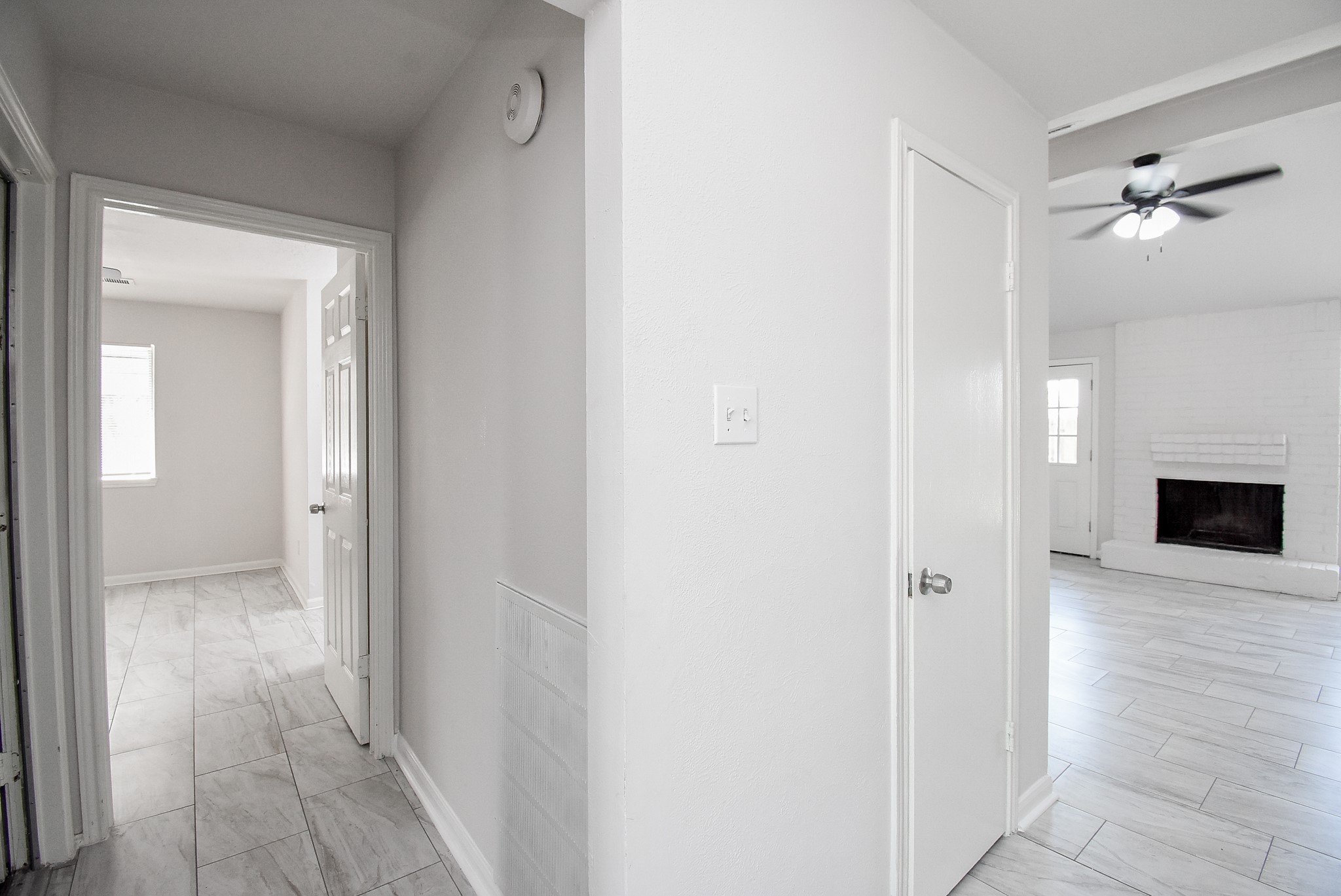 9527 Kingsvalley Drive Houston, TX 77075 - Photo 8 of 45 a view of a hallway with wooden floor and a fireplace