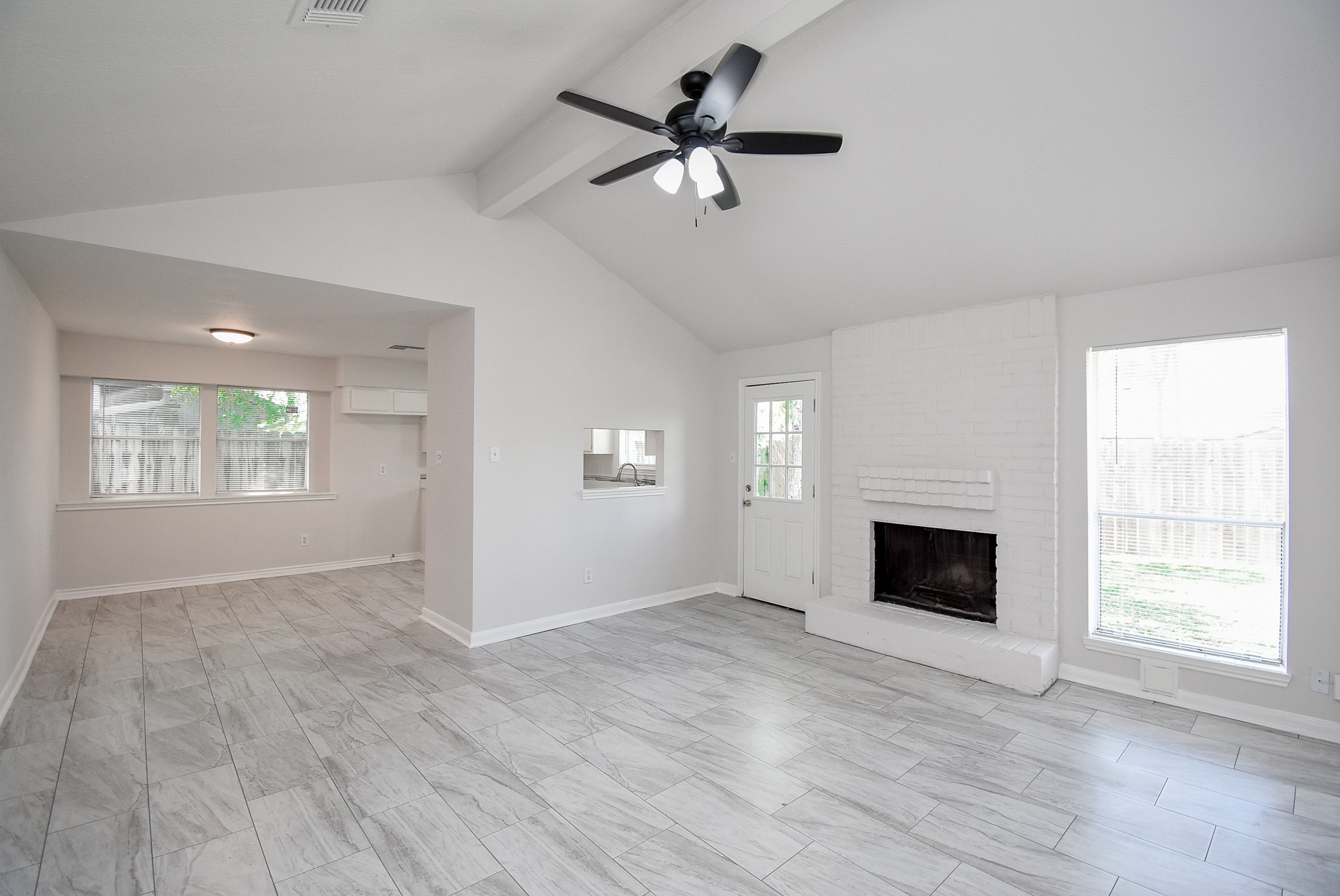 9527 Kingsvalley Drive Houston, TX 77075 - Photo 9 of 45 a view of an empty room with a fireplace and a window