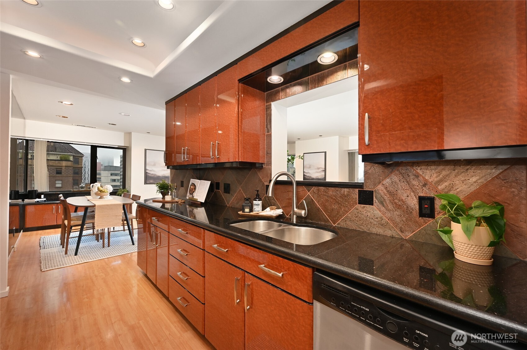 1301 Spring Street, Unit 10F Seattle, WA 98104 - Photo 12 of 36 a kitchen with stainless steel appliances granite countertop sink stove and cabinets