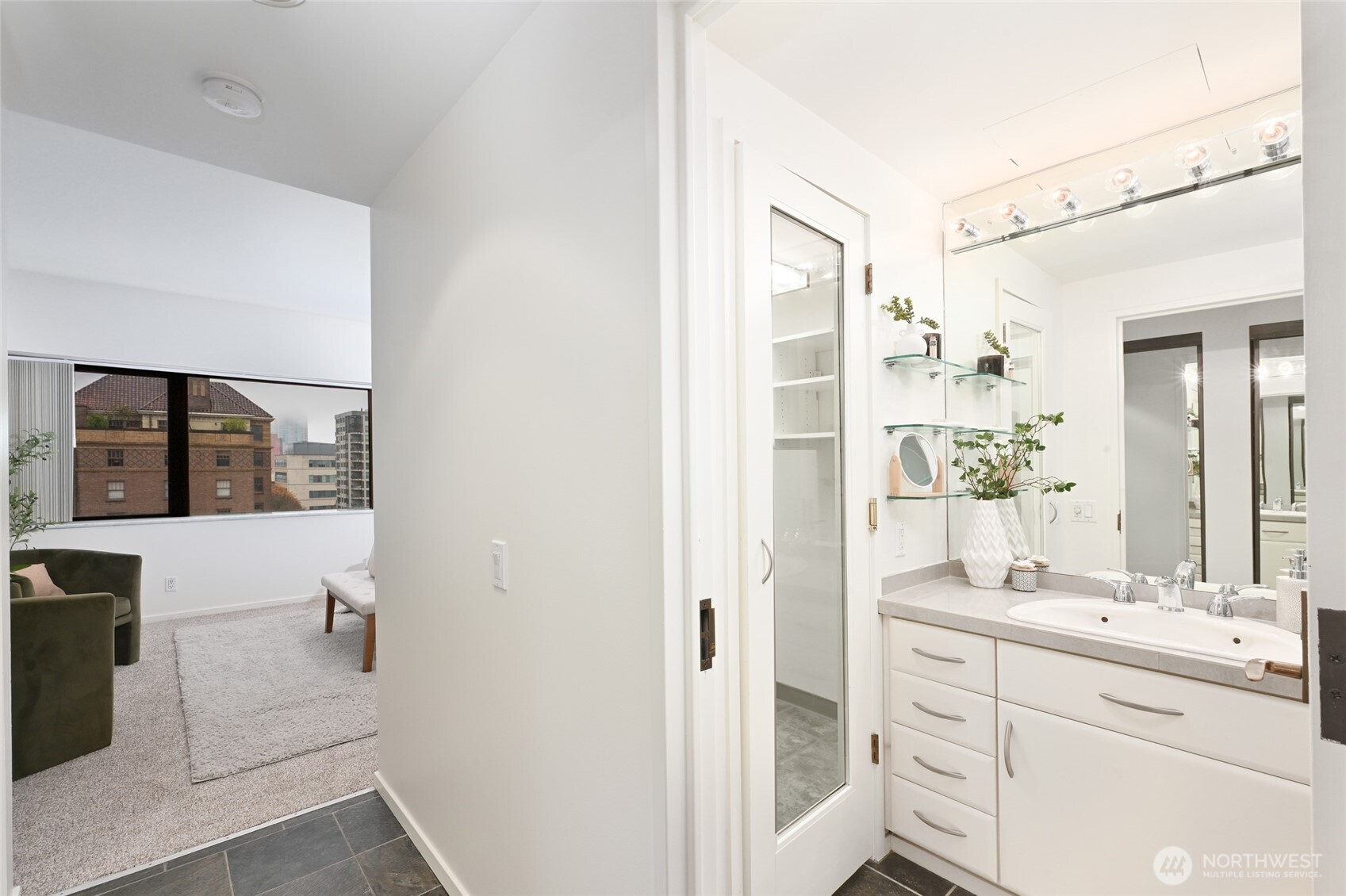 1301 Spring Street, Unit 10F Seattle, WA 98104 - Photo 16 of 36 a bathroom with a sink a mirror and a shower