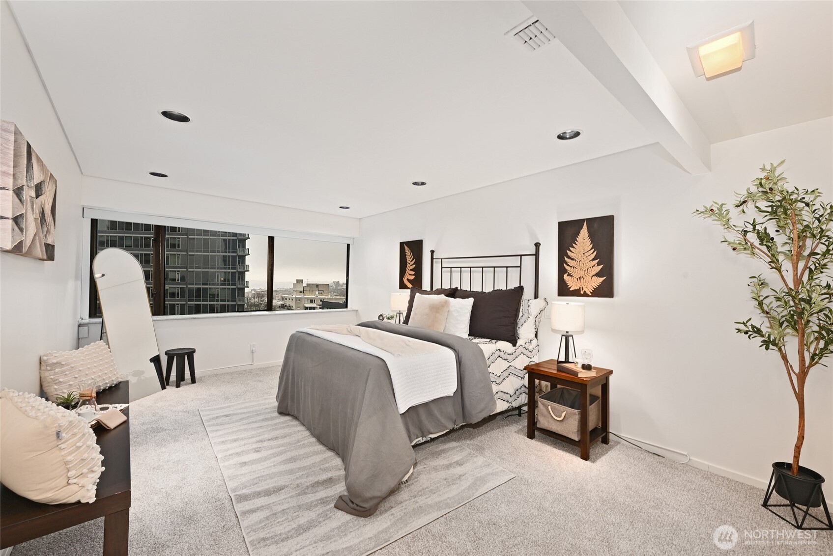 1301 Spring Street, Unit 10F Seattle, WA 98104 - Photo 19 of 36 a spacious bedroom with a bed and window