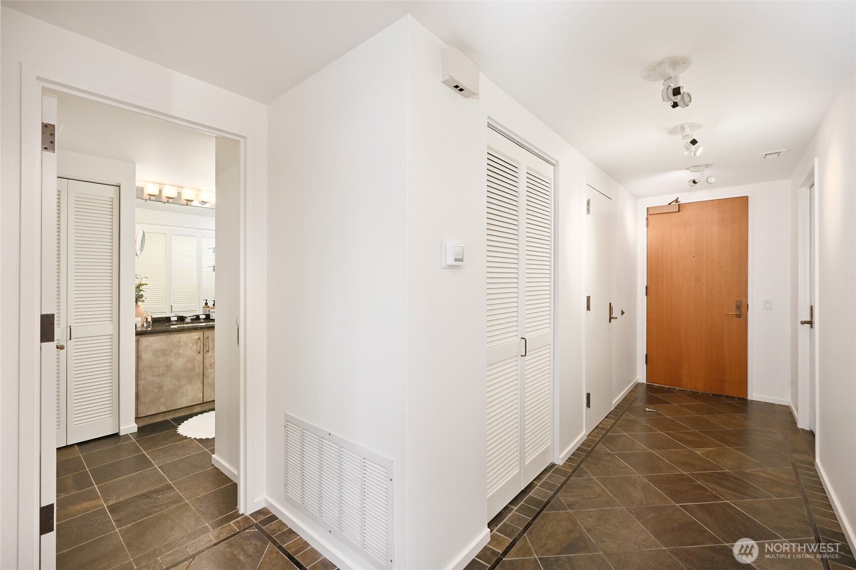 1301 Spring Street, Unit 10F Seattle, WA 98104 - Photo 22 of 36 a view of a hallway with wooden floor