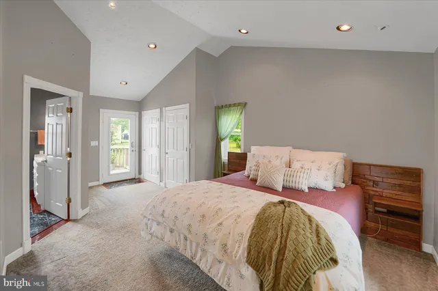 a spacious bedroom with a bed and a dresser