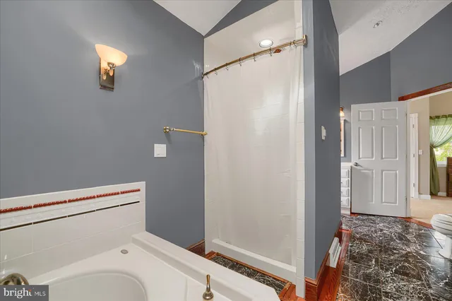 a bathroom with a toilet and a shower