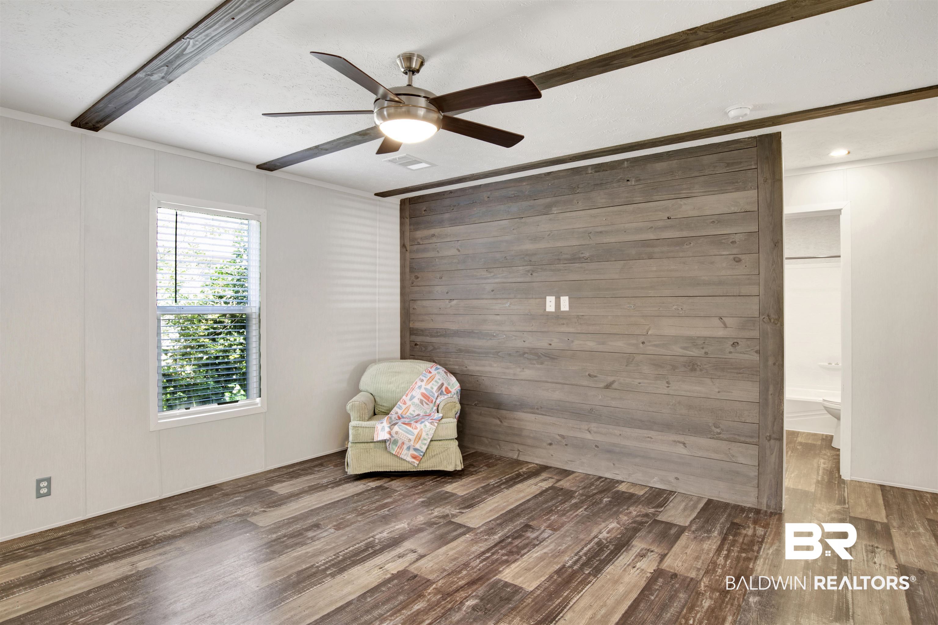 1411 Ridgewood Drive Lillian, AL 36549 - Photo 9 of 30 Unfurnished room with wood-type flooring, crown molding, beam ceiling, and ceiling fan
