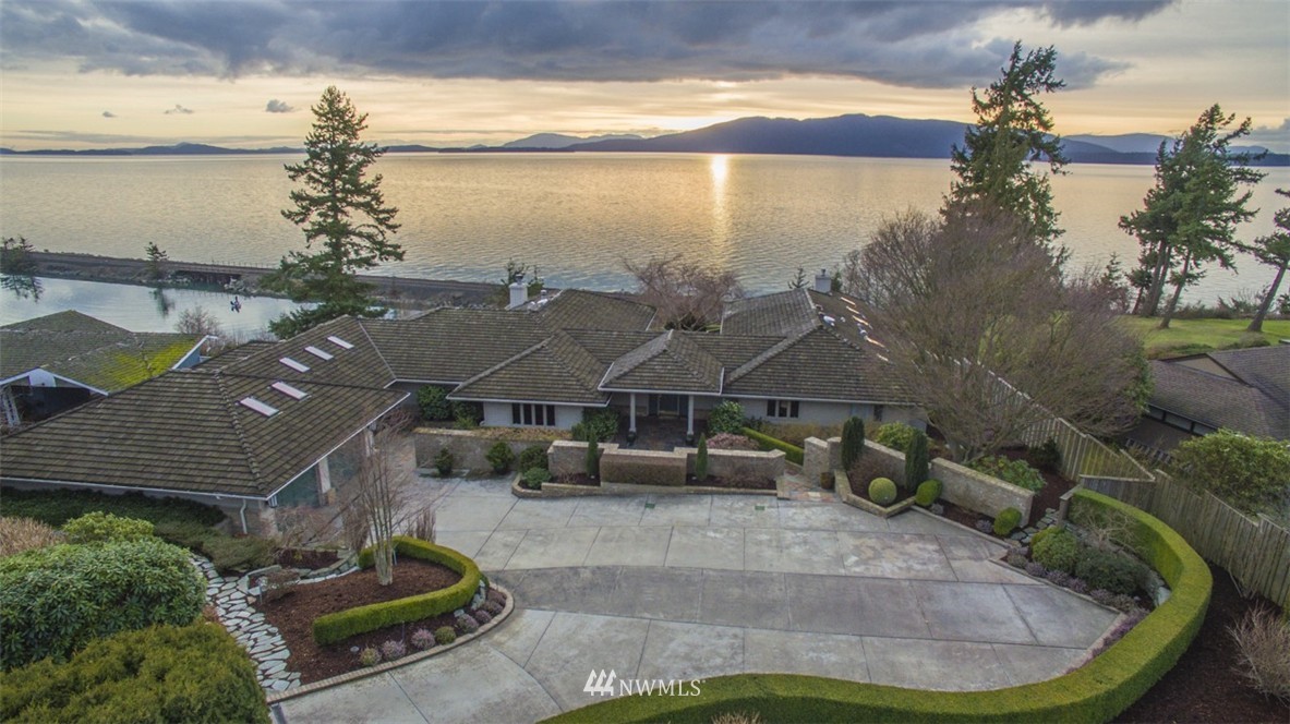 a aerial view of a house with lake view and a yard