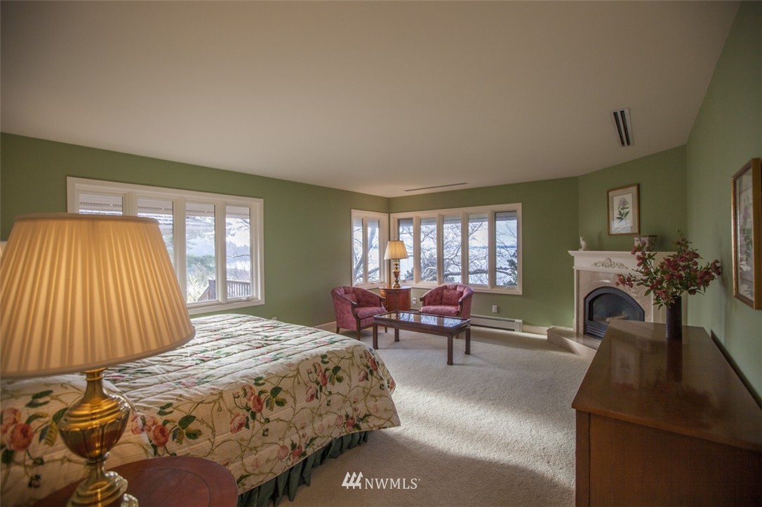 346 Bayside Road Bellingham, WA 98225 - Photo 11 of 25 a bedroom with a bed and a fireplace