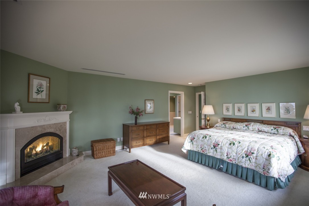 346 Bayside Road Bellingham, WA 98225 - Photo 12 of 25 a bedroom with a bed and a fireplace