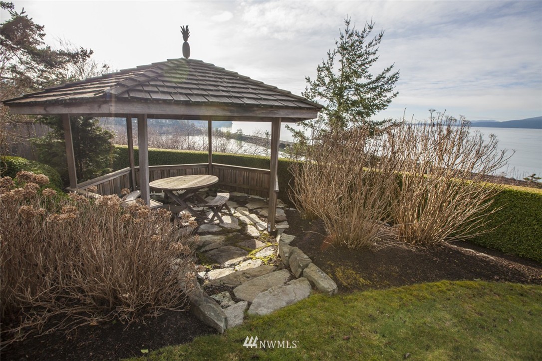 346 Bayside Road Bellingham, WA 98225 - Photo 24 of 25 a backyard of a house with table and chairs under an umbrella