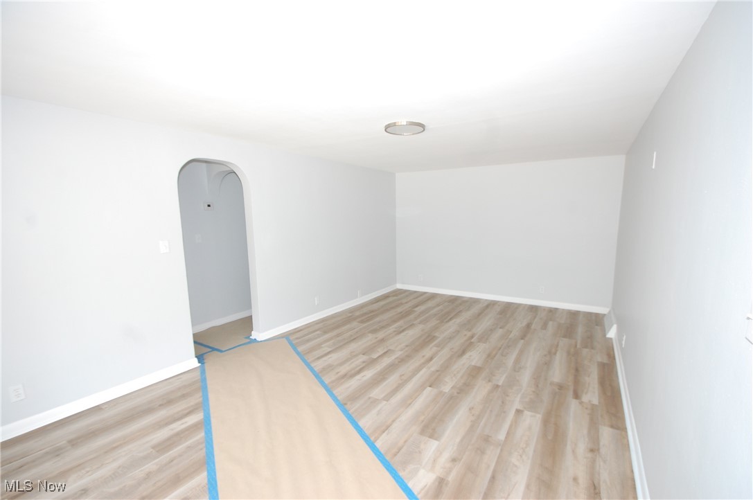 6284 Herbert Road Canfield, OH 44406 - Photo 10 of 24 Unfurnished room featuring light wood-style flooring, baseboards, and arched walkways