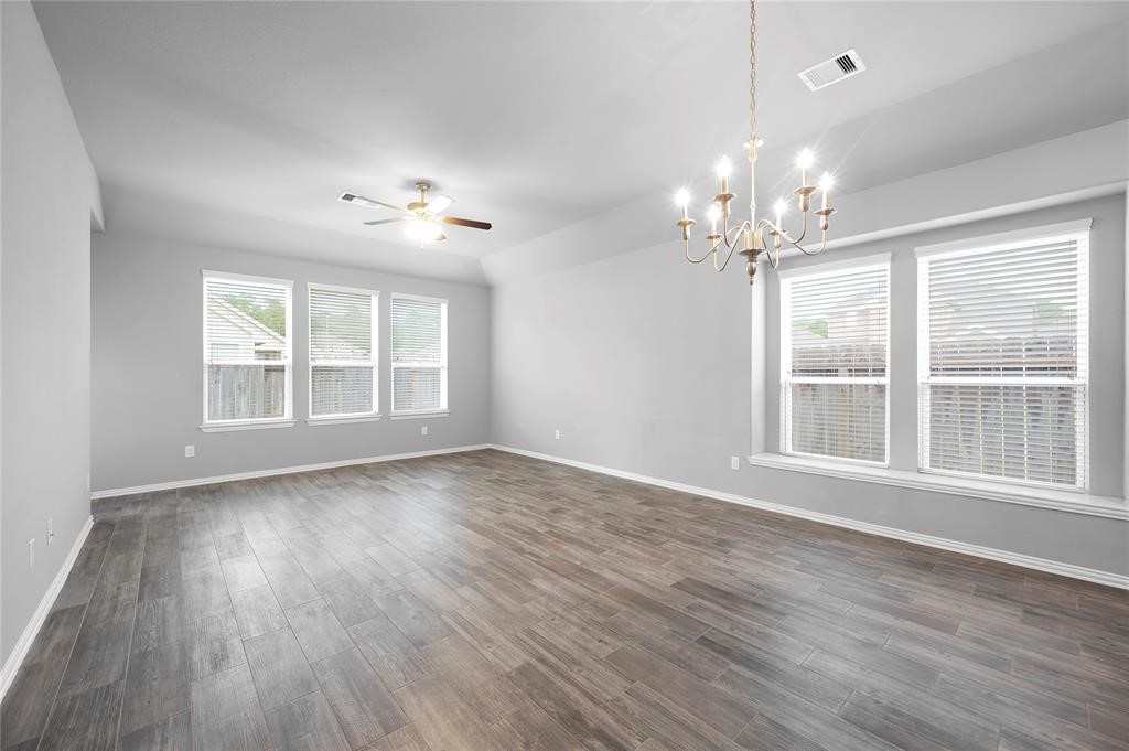 3137 Dunsmore Manor Court Spring, TX 77386 - Photo 15 of 32 a view of an empty room with wooden floor and a window