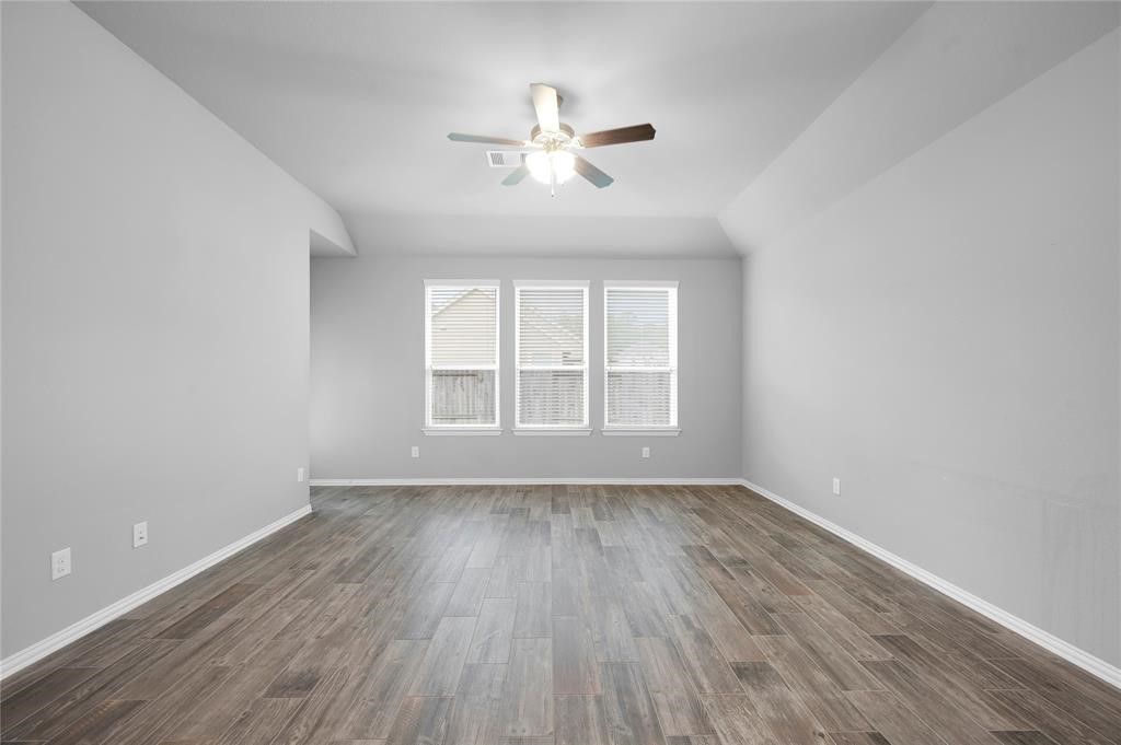 3137 Dunsmore Manor Court Spring, TX 77386 - Photo 16 of 32 wooden floor in an empty room with a window