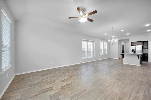 a view of a livingroom with a ceiling fan and window