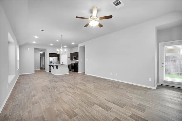 a view of kitchen with furniture and a ceiling fan