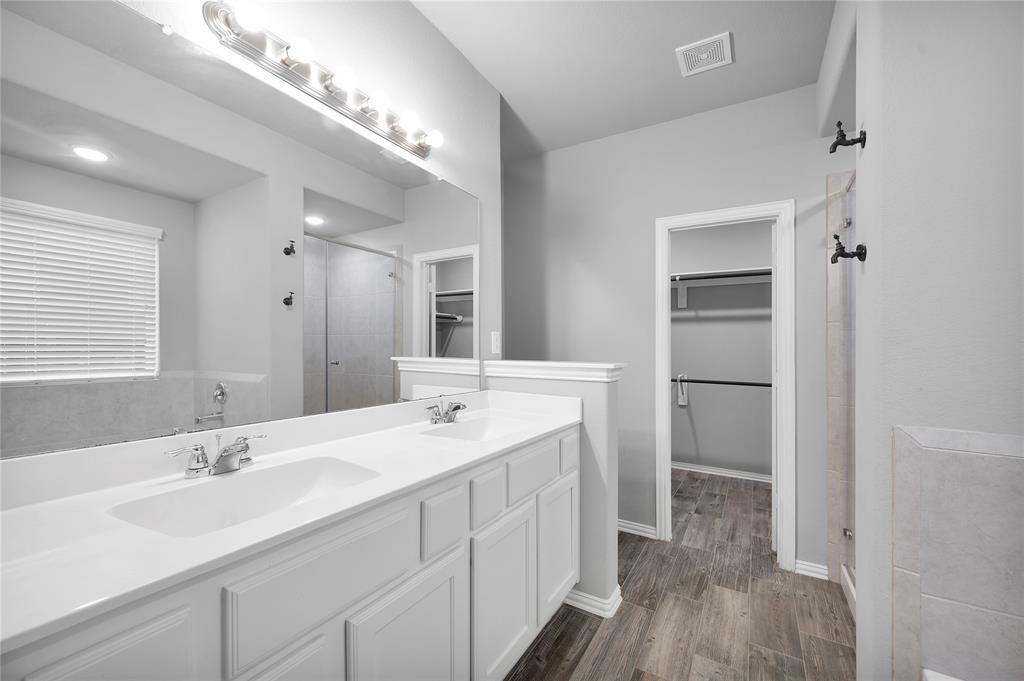 3137 Dunsmore Manor Court Spring, TX 77386 - Photo 24 of 32 a bathroom with a double vanity sink and mirror