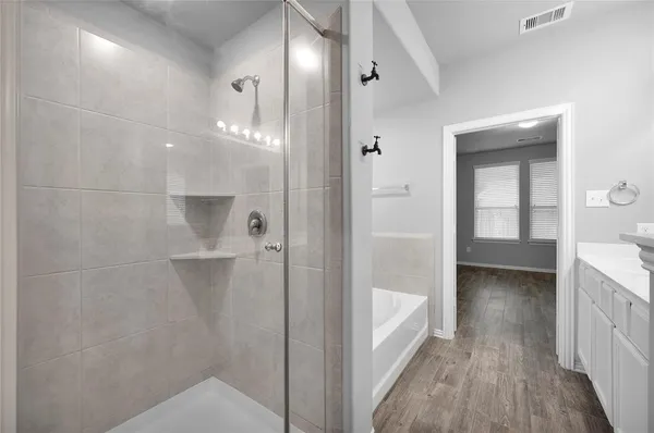a bathroom with a double vanity sink and mirror