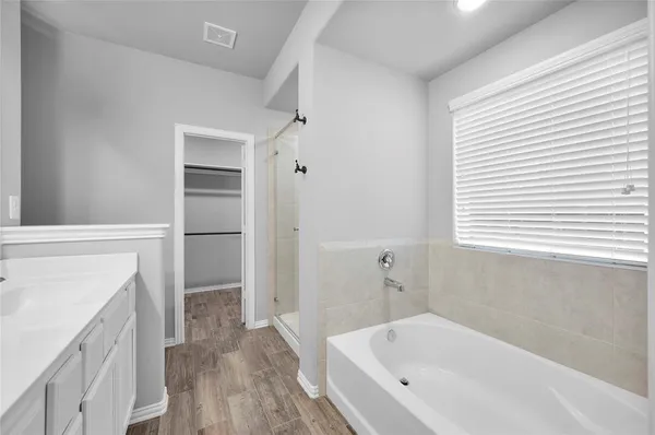 a bathroom with a bathtub and shower