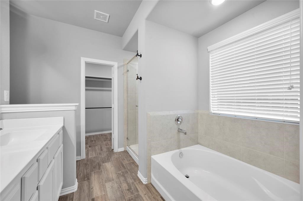 3137 Dunsmore Manor Court Spring, TX 77386 - Photo 26 of 32 a bathroom with a bathtub and a shower