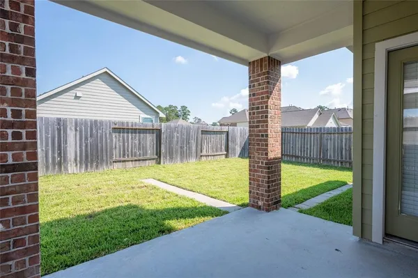 a view of a porch with a big yard and large tree