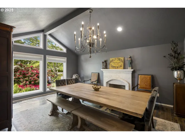 a living room with furniture a fireplace and a table