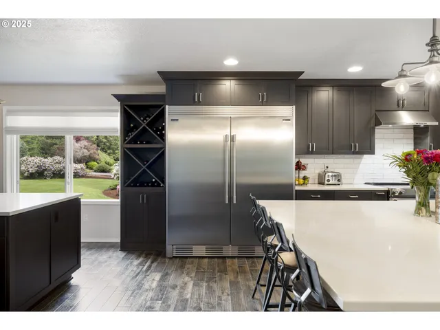 a living room with furniture and a kitchen