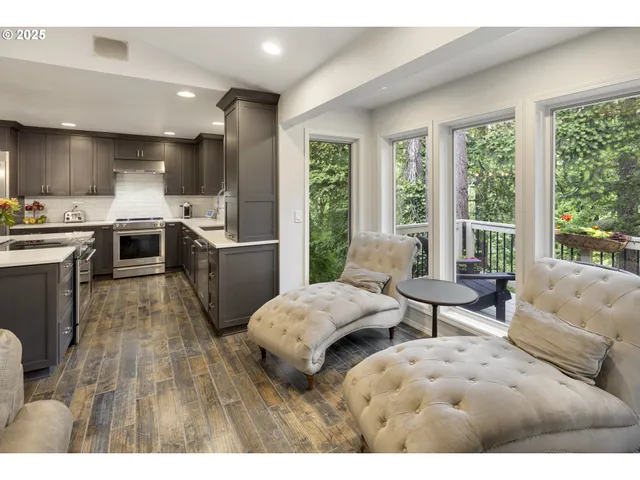 a living room with furniture kitchen view and a fireplace