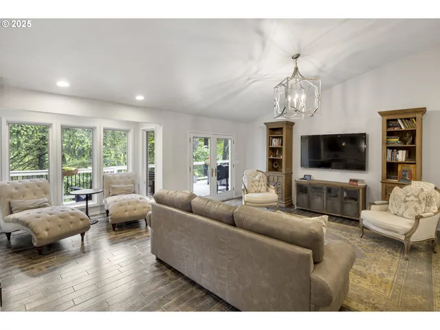 a view of a patio with couches chairs and wooden floor