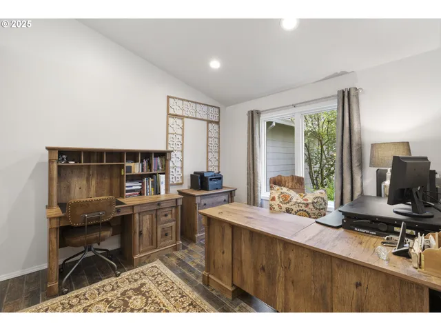 a spacious bedroom with a bed mirror and a chandelier
