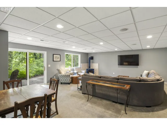 a living room with furniture a air conditioner vent and a window