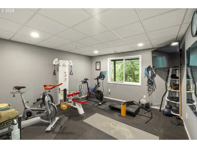 a bedroom with a bed a table and a large window